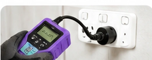 Portable electrical appliance tester connected to a power outlet